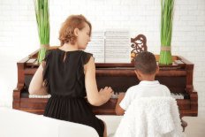 Private piano teacher with her student